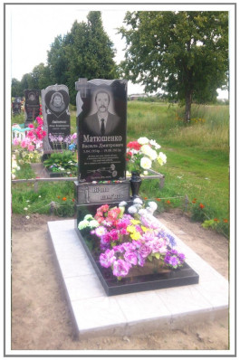Мужской гранитный памятник с резным крестом и цветником